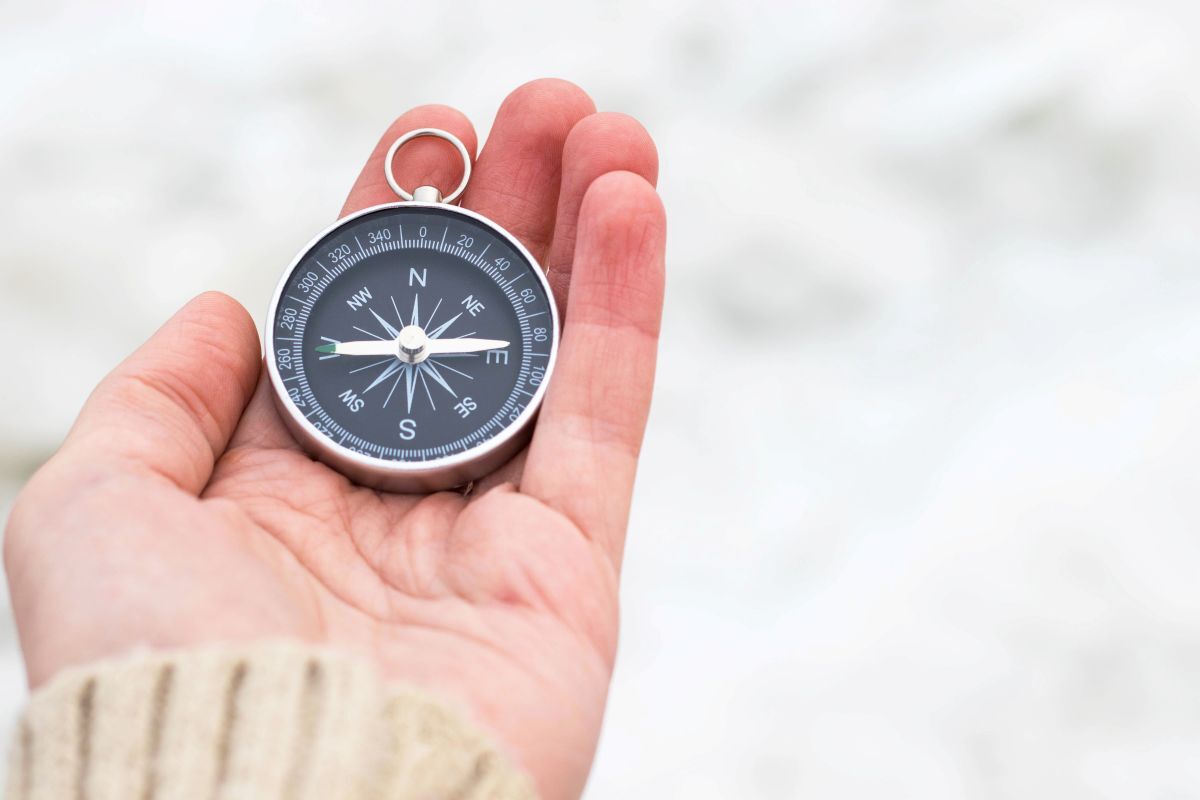 hand holding compass hand holding compass